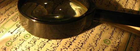 Quran and magnifying glass